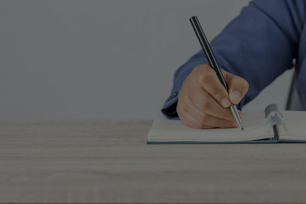 man writing in notebook blog 39